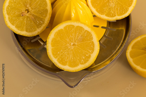 sliced lemons, and a manual juicer