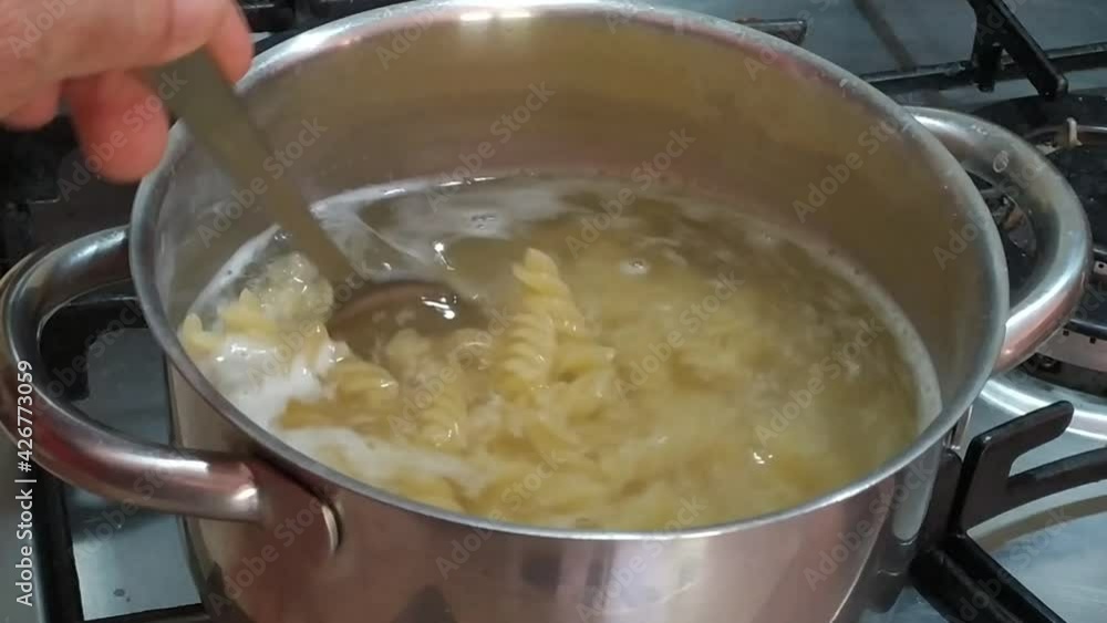 Boil the pasta in the pot.
Pot with hot water and Italian pasta while cooking.
cook in a pan. 4K video Boil the pasta in the pot.
Pot with hot water and Italian pasta while cooking.
cook in a pan. 4K video