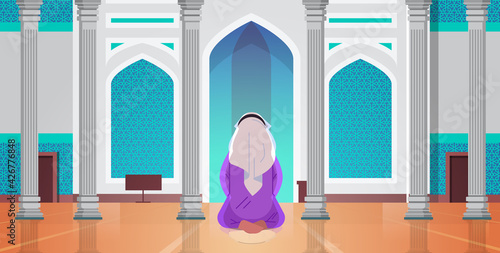 religious muslim man kneeling and praying inside mosque building ramadan kareem holy month religion concept rear view full length horizontal