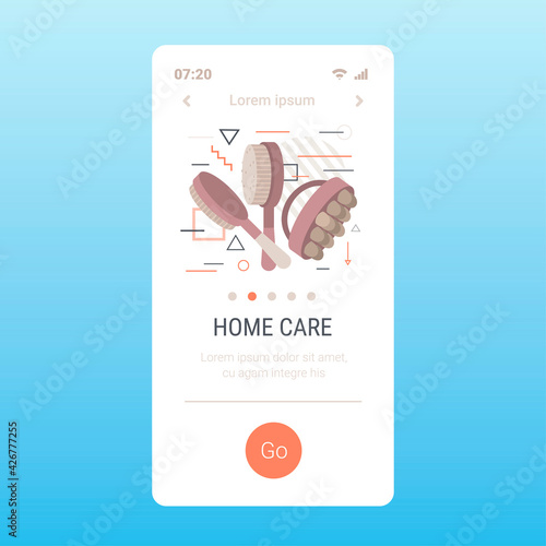 wooden brushes for dry body anti-cellulite massage cellulite treatment dry brushing skincare concept smartphone screen mobile app copy space