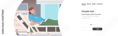 pregnant woman lying in hospital bed before childbirth maternity pregnancy concept portrait horizonal copy space