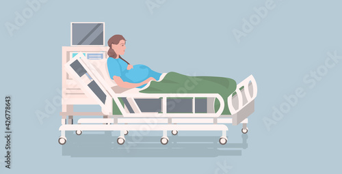 pregnant woman lying in hospital bed before childbirth maternity pregnancy concept full length