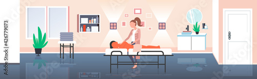 woman receiving body contouring masseuse makes anti cellulite relaxing procedures skin care massage therapy concept modern spa salon interior horizontal full length