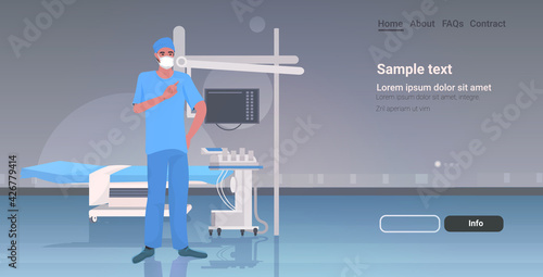 male doctor surgeon in protective mask and gloves hospital medical clinic worker in uniform medicine healthcare concept modern clinic surgery room interior full length copy space horizontal
