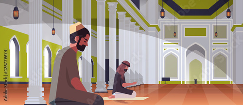 religious muslim men couple kneeling and praying inside nabawi mosque building ramadan kareem holy month religion concept full length horizontal