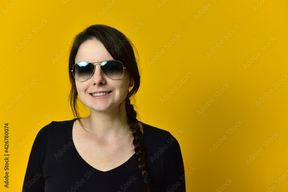 Beautiful girl wearing sunglasses on yellow background. Beautiful girl wearing sunglasses on yellow background.