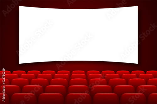 Cinema hall with white screen and red chairs