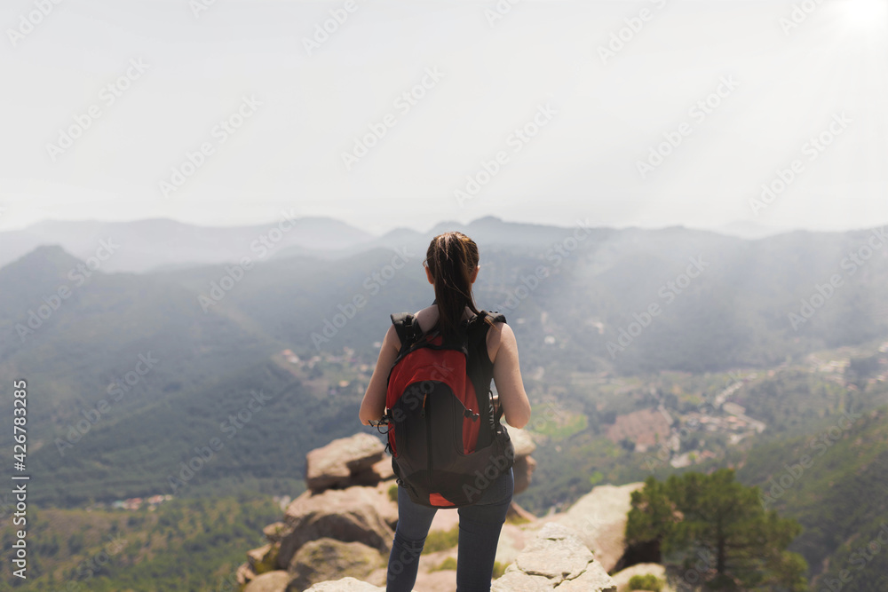 girl with backpack in the mountain
