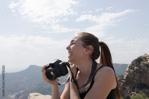 girl with camera on the mountain