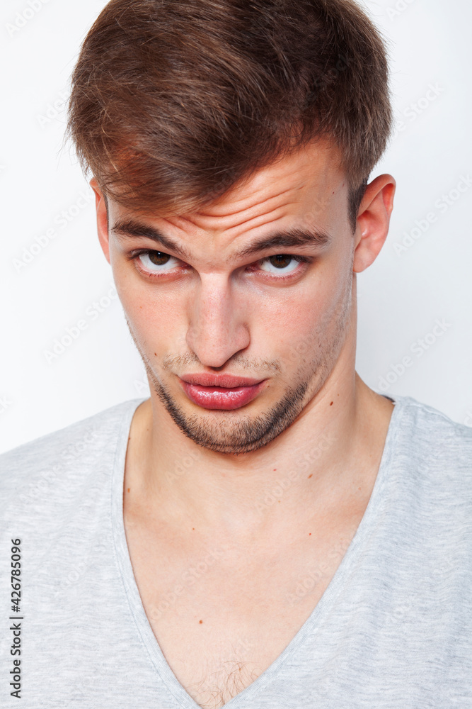 Obraz premium young handsome teenage hipster guy posing emotional, happy smiling against white background isolated, lifestyle people concept
