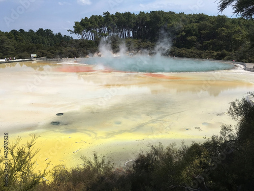 volcanic boiling thermal lake colorful mineral sands sulfuric steam clouds New Zealand