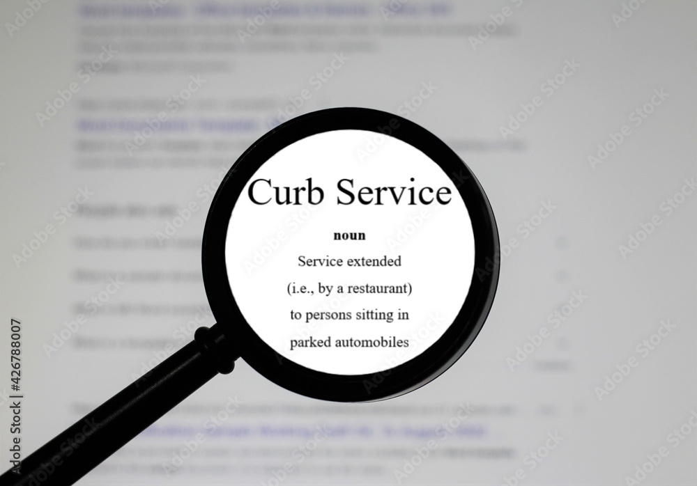 Selective focus on word Curb service, word in a dictionary. Close up of an English dictionary page with word curb service Selective focus on word Curb service, word in a dictionary. Close up of an English dictionary page with word curb service
