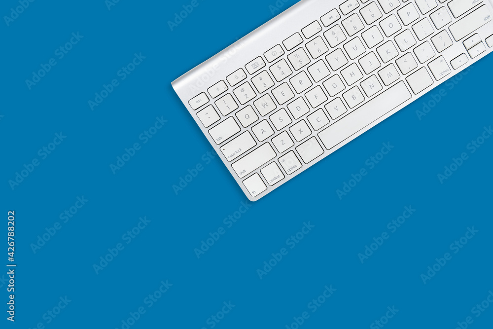 white computer keyboard on sky blue background