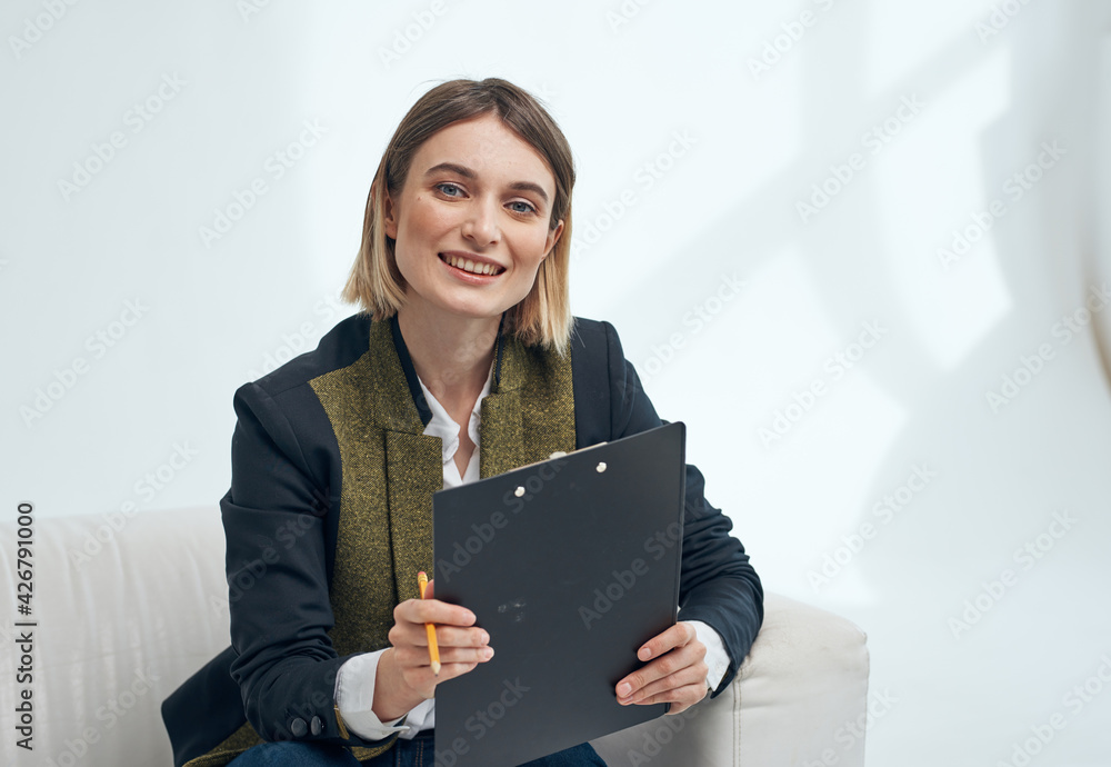 Woman manager with player documents indoors near the window Woman manager with player documents indoors near the window
