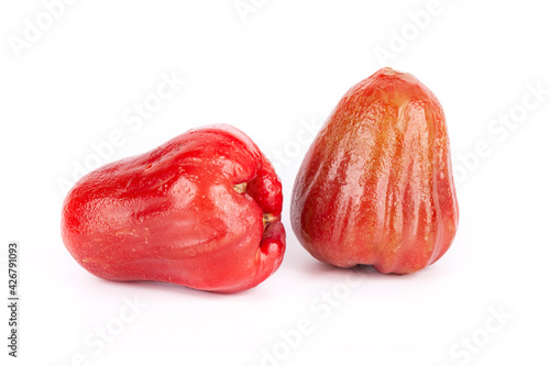 Two whole Java apples, one lies on its side on a white background, isolated