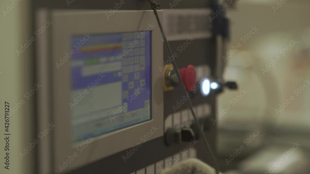 Hand of industrial operator uses computer screen in factory Hand of industrial operator uses computer screen in factory