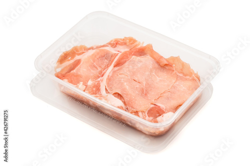 fresh Sliced raw pork ids isolated in plastic box on white clear background. Clipping Paths.