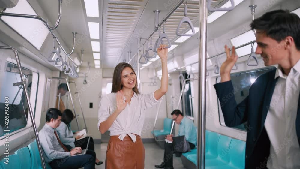 Businesswoman standing on the skytrain or subway greets friend businessman on their way to working transportation people diversity lifestyle concept. Businesswoman standing on the skytrain or subway greets friend businessman on their way to working transportation people diversity lifestyle concept.