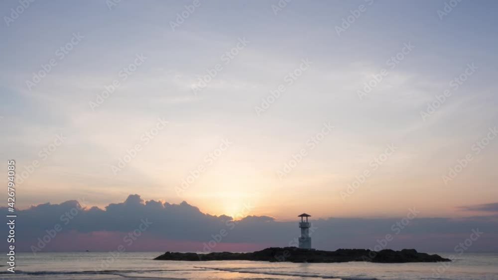 sunlight shines through dramatic gray clouds over the ocean. sunset at the horizon. beautiful ray sunbeams shine over a wide atmosphere. timelapse of waves sunlight shines through dramatic gray clouds over the ocean. sunset at the horizon. beautiful ray sunbeams shine over a wide atmosphere. timelapse of waves