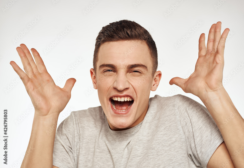 cheerful emotional man gesturing with his hands close-up light background cheerful emotional man gesturing with his hands close-up light background