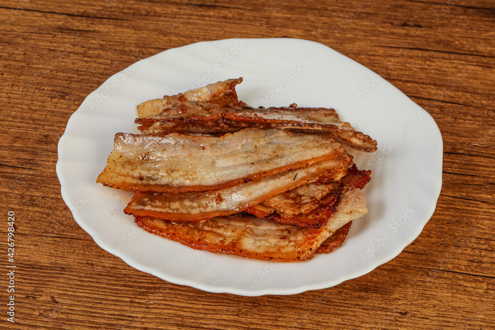 Roasted juicy bacon in the plate Roasted juicy bacon in the plate
