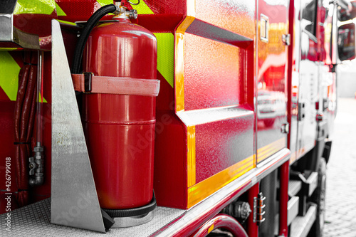 Modern red and yellow fire fighter truck equipped with latest fire extinguishing and air cylinders for rescue operations. Transportation and technology concept. Close up high quality photo