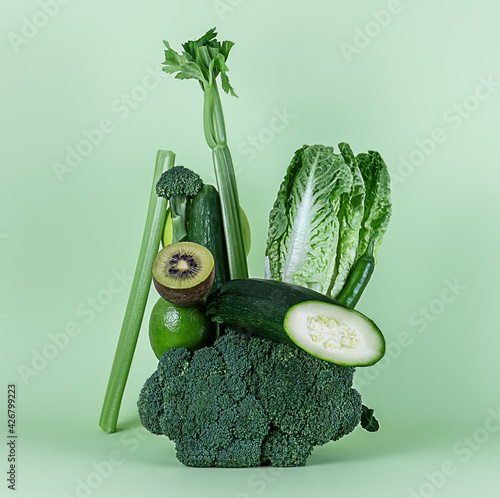 Fresh green vegetables and fruits for a healthy smoothie or alkaline diet. Equilibrium floating food balance. photo