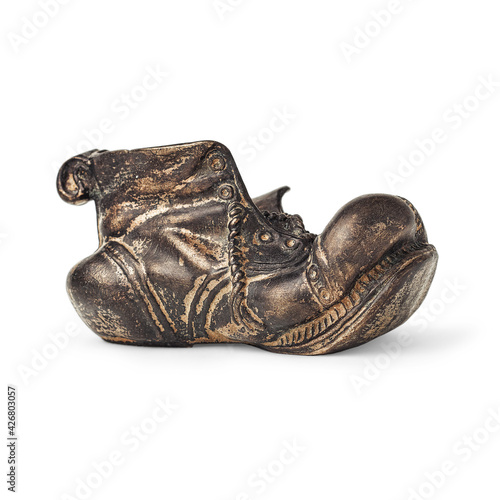 an old metal shoe is isolated on a white background with a shadow