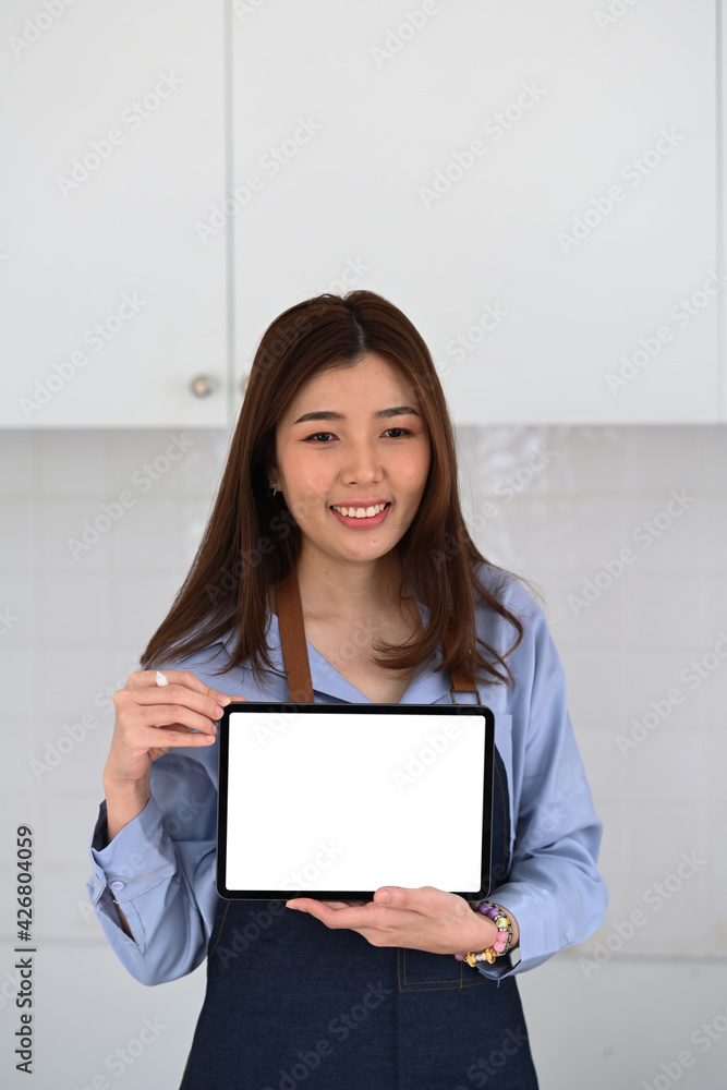Portrait of small business owner holding and showing digital tale with blank screen. Portrait of small business owner holding and showing digital tale with blank screen.