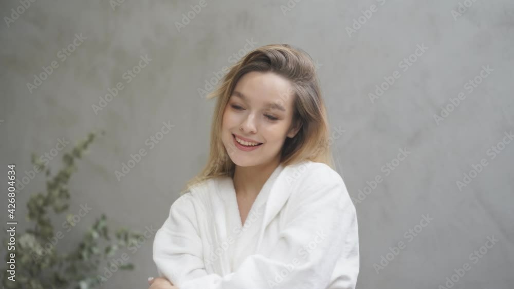 Portrait Of Young Lovely Female Enjoying Healthy Fresh Facial Skin, Standing In Front Of Mirror In Home Bathroom, Smiling. Daily Hygiene And Skincare