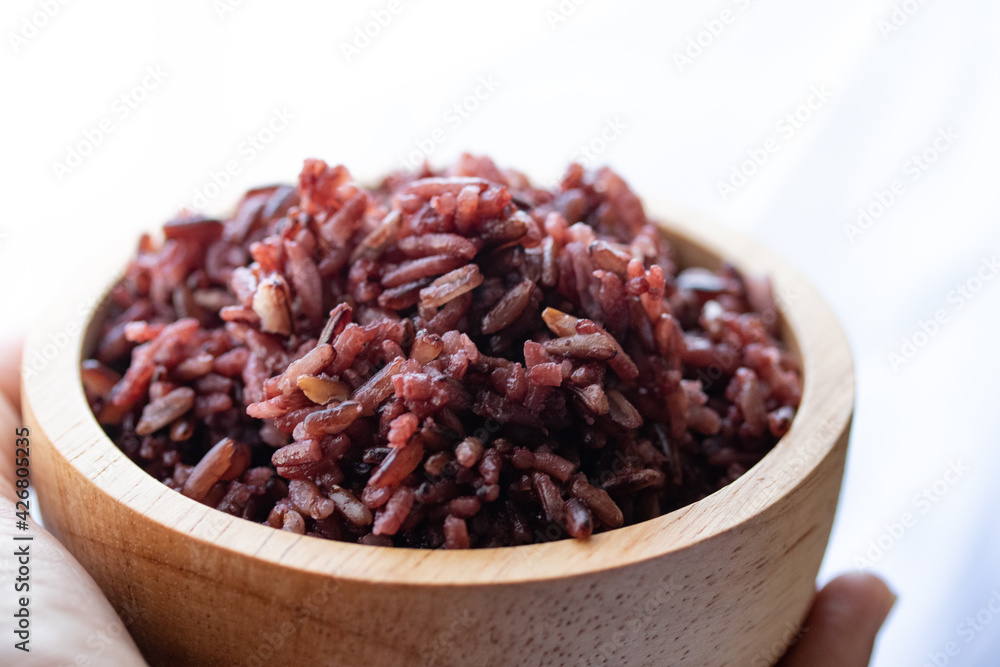 Close-up. Riceberry rice in a wooden bowl. Close-up. Riceberry rice in a wooden bowl.
