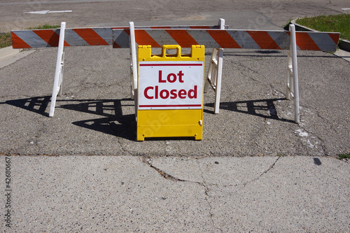 Lot Closed - temporary traffic sign and road block at a parking lot entrance photo