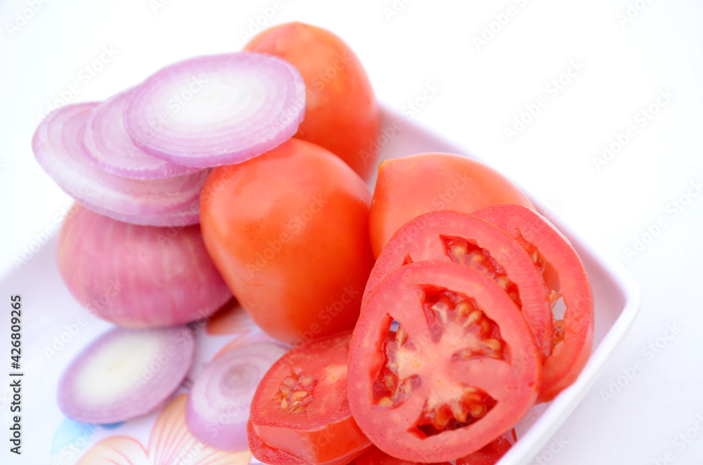 sliced red tomato with onion healthy food isolated on white background. sliced red tomato with onion healthy food isolated on white background.