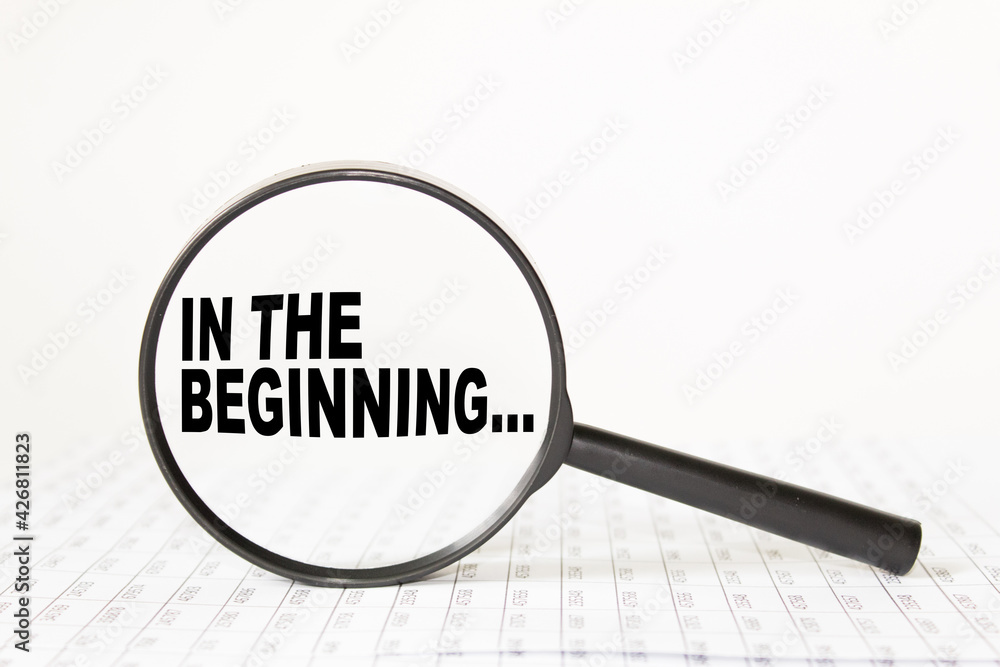 words IN THE BEGINNING in a magnifying glass on a white background. business concept words IN THE BEGINNING in a magnifying glass on a white background. business concept