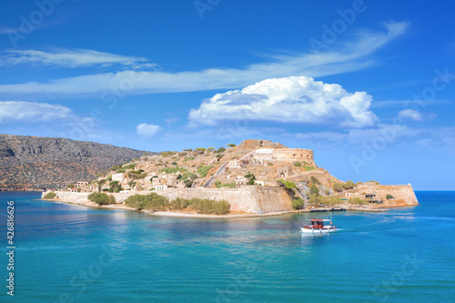 View of the island of Spinalonga with calm sea. Here were isolated lepers, humans with the Hansen's desease, gulf of Elounda, Crete, Greece. 