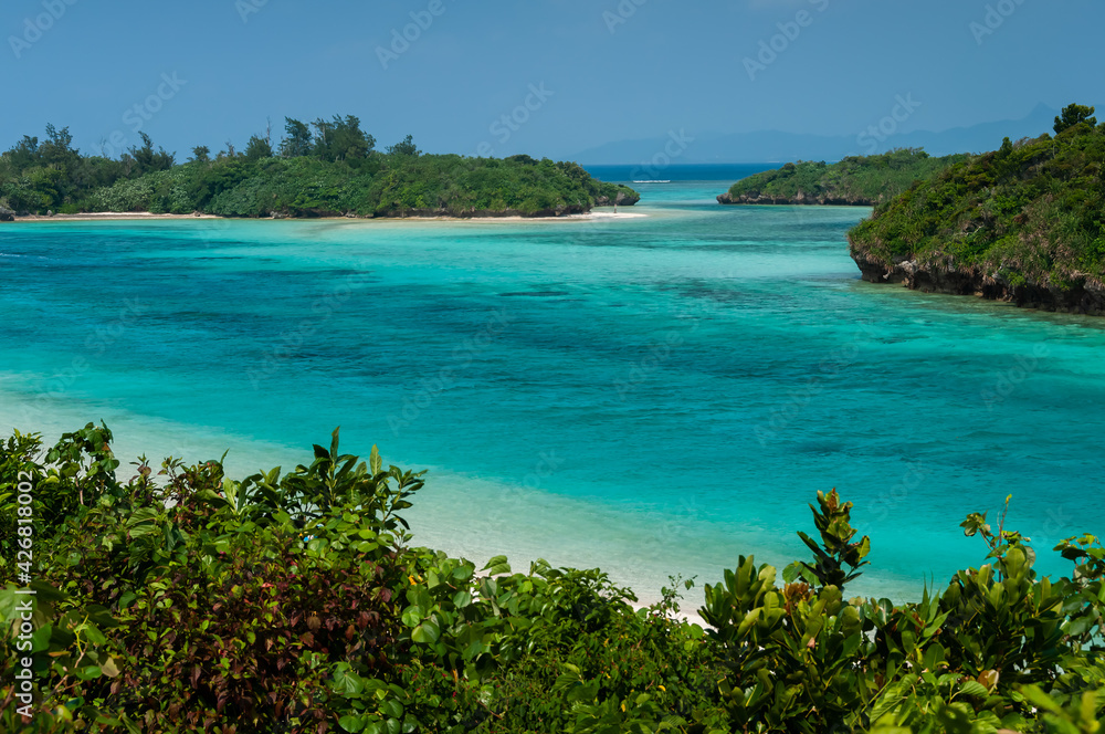 Impressive pristine scenery of Kabira Bay with its crystal clear turquoise waters, where its flows in the midst of a channel of vegetation. Incredible scene seen from above.