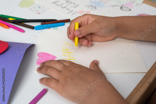 Girls' hands making hand drawings and cards for Father's Day