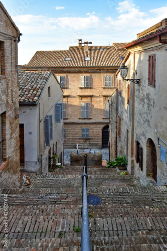 Fototapeta Naklejka Na Ścianę i Meble -  A narrow street between the old houses of Civitanova Alta, a medieval town in the Marche region of Italy.