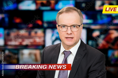 Quadro su tela An anchorman reporting live breaking news sitting in Tv studio