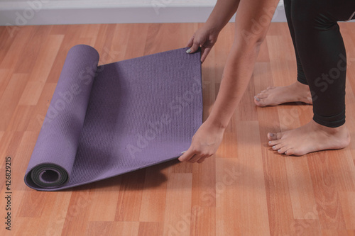 Young woman with a yoga mat