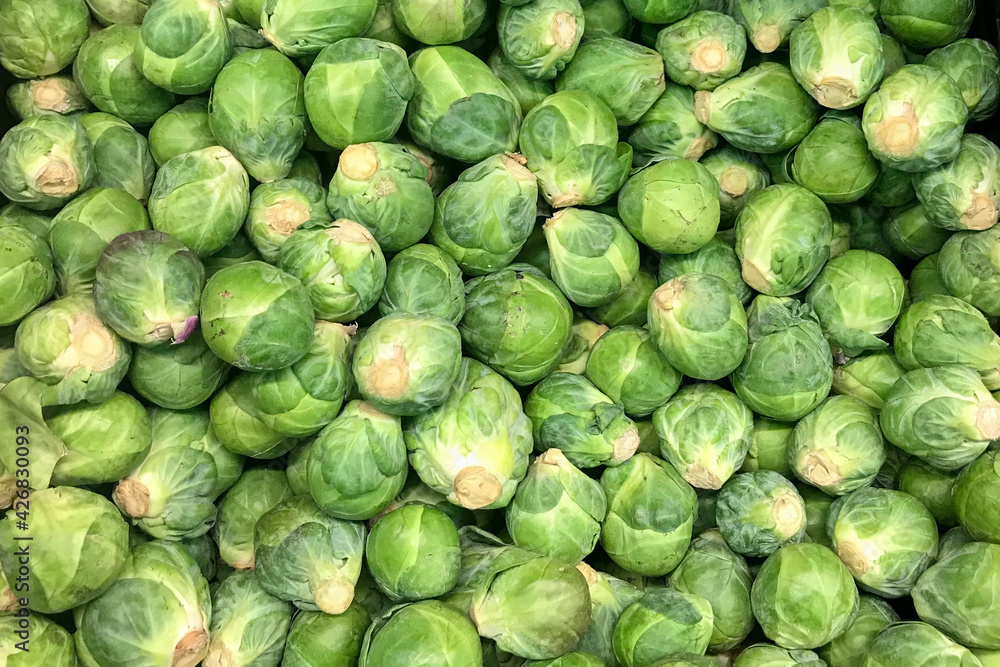 Brussels sprout piled on the market stall. Green vegetables Brussels sprout piled on the market stall. Green vegetables