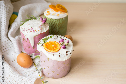 Glazed easter cake decorated with oranges and eggs on wooden table. Happy Easter Holidays