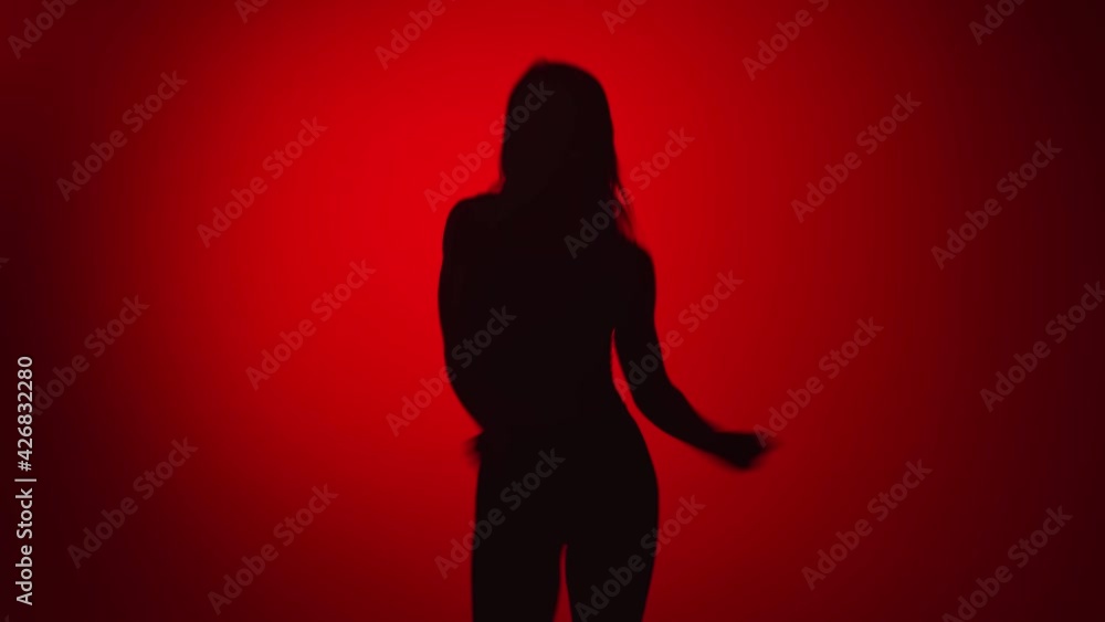 Silhouette of feminine with flexible slim body dancing jumping. Shot on RED Raven 4k Cinema Camera Silhouette of feminine with flexible slim body dancing jumping. Shot on RED Raven 4k Cinema Camera