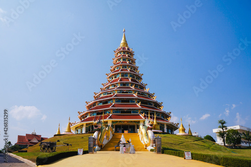 Wat Huay Pla Kang Temple, Beautifully with high stupa and elegance blue sky in the background. Located in Chiang Rai, Thailand.