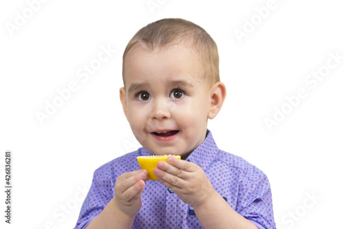 Boy 2-3 years old with lemon in hands, White background, isolated