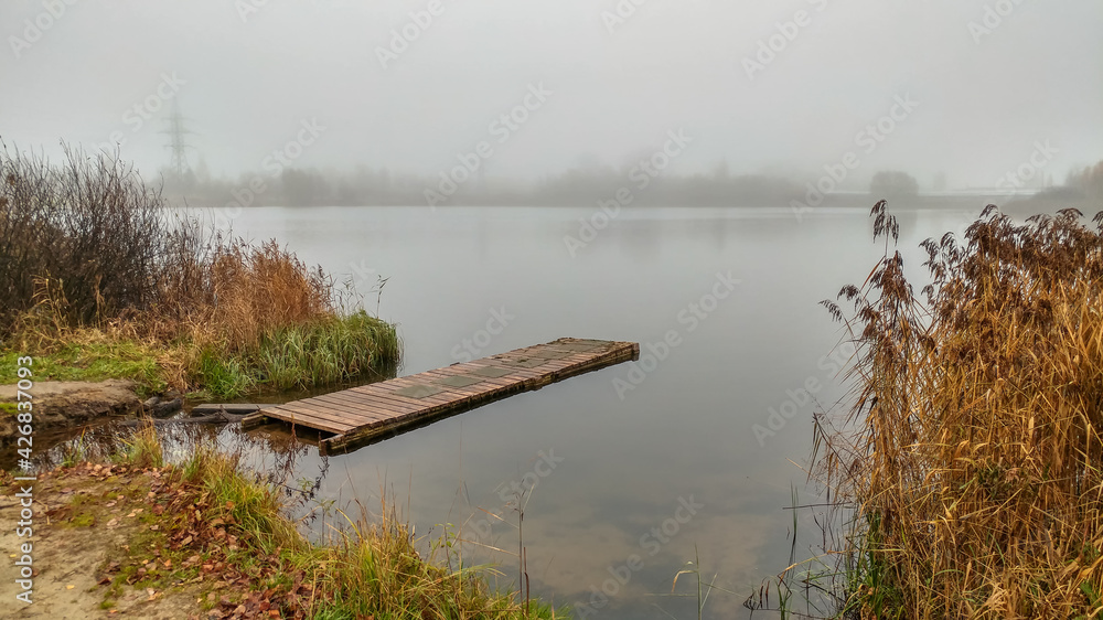 Foggy morning by the lake in autumn