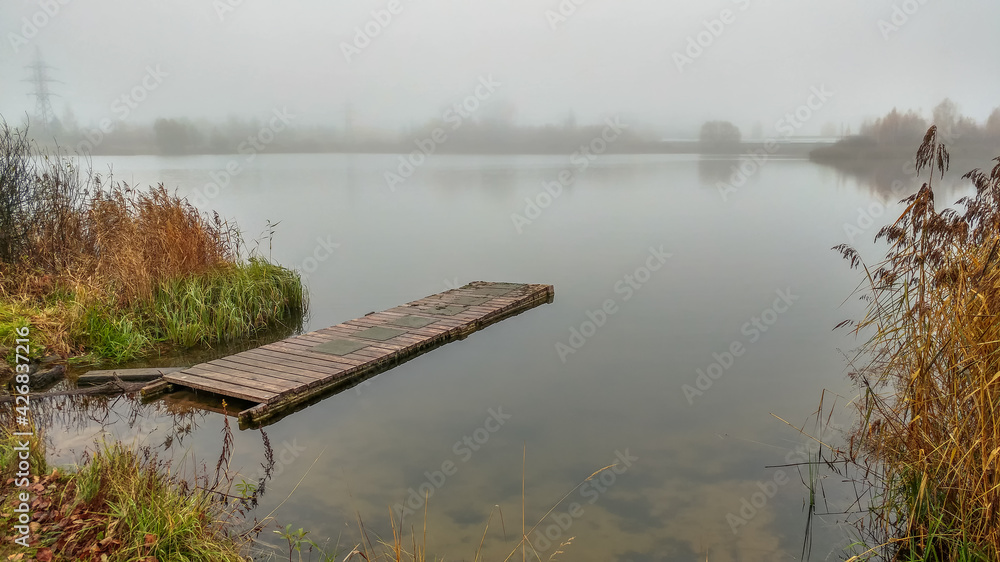 Foggy morning by the lake in autumn