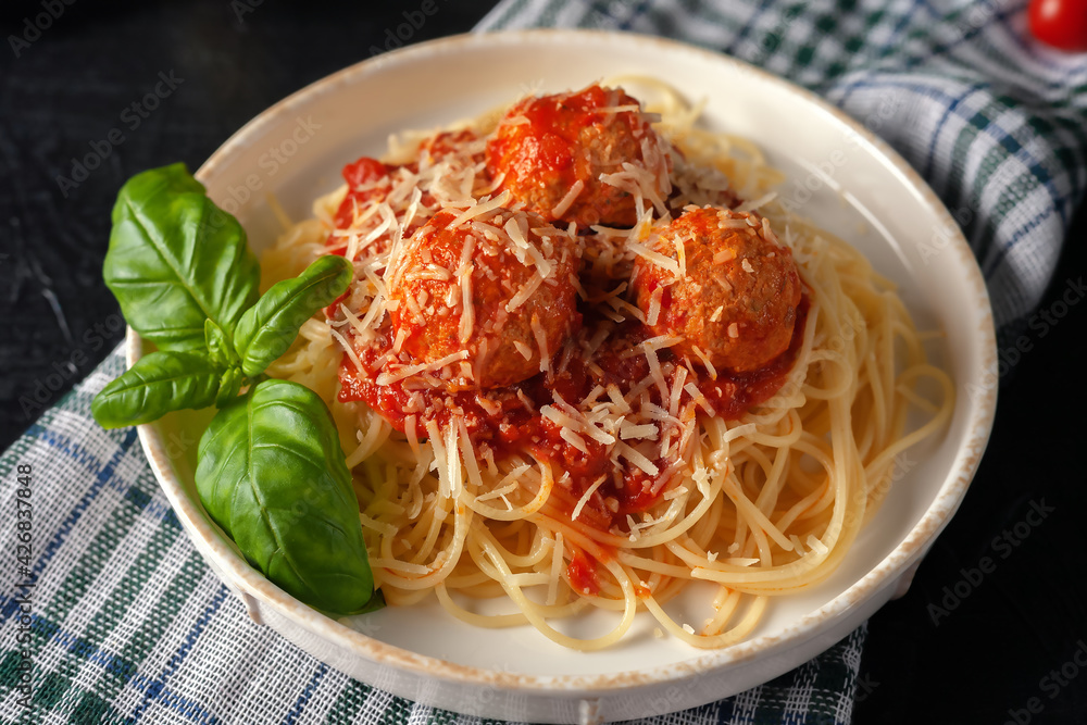 Spaghetti pasta with meatballs, parmesan and tomato sauce, selective focus