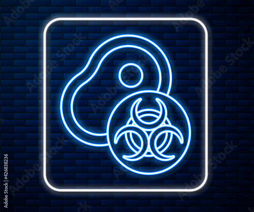 Glowing neon line Genetically modified meat icon isolated on brick wall background. Syringe being injected to meat. Vector