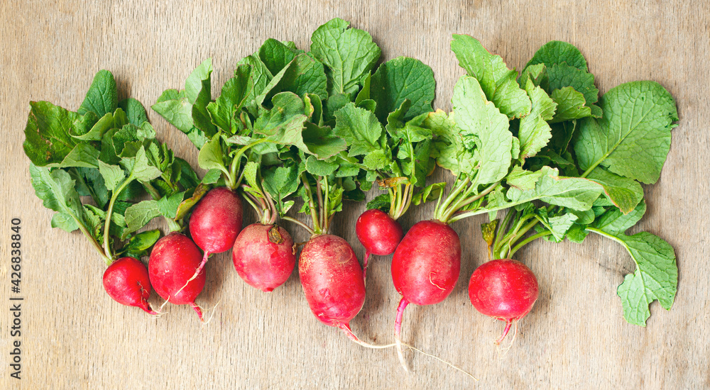 Fresh radish heap on wooden background. Fresh radish heap on wooden background.